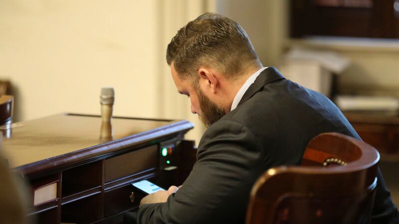 FILE - Republican South Carolina Rep. R.J. May of Lexington sits at his new desk during the...