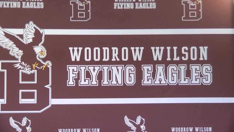 Four football players and one soccer player at Woodrow Wilson High School sign their national...